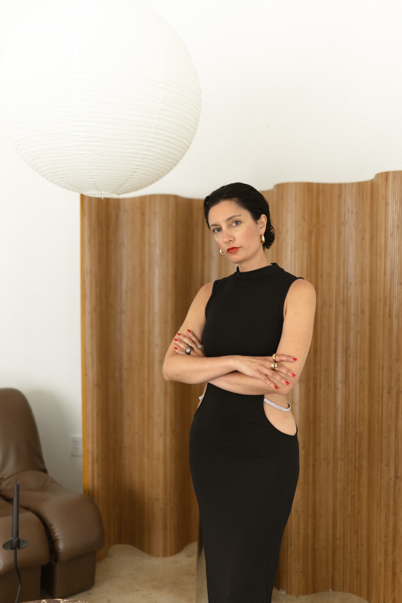 Ilaria Del Bono in a black dress against a warm wooden backdrop
